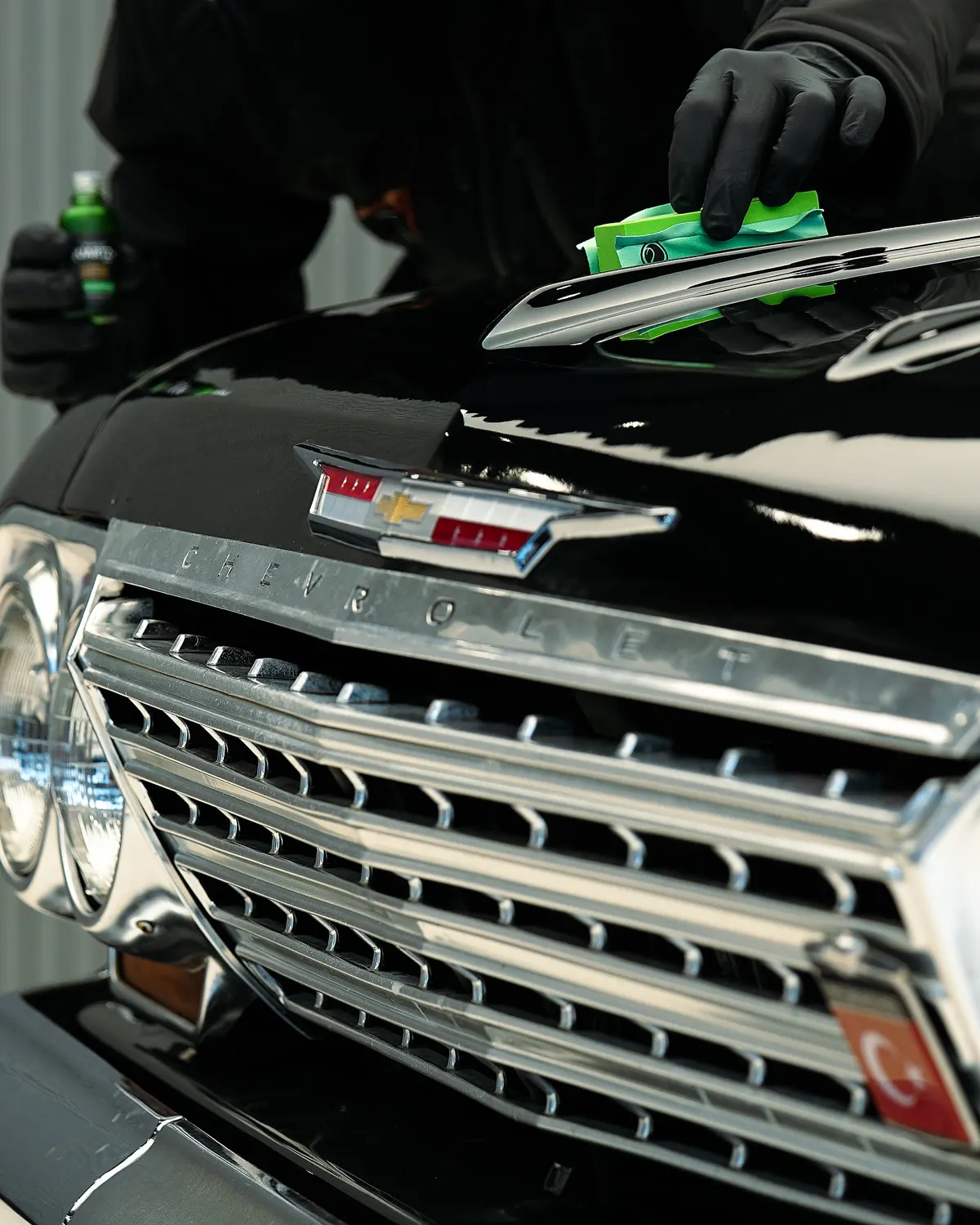Capla technician applying ceramic coating to a vehicle bonnet